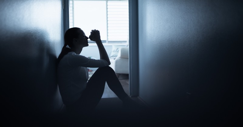 A woman praying in a hallway, Christians must have faith