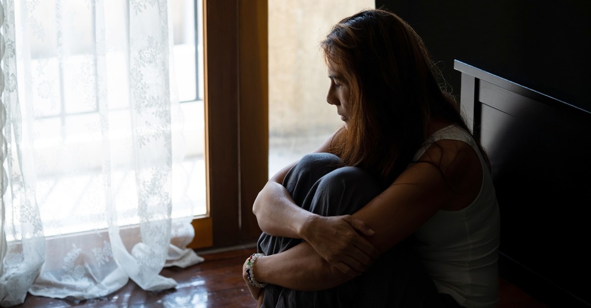 Woman sitting in a corner alone