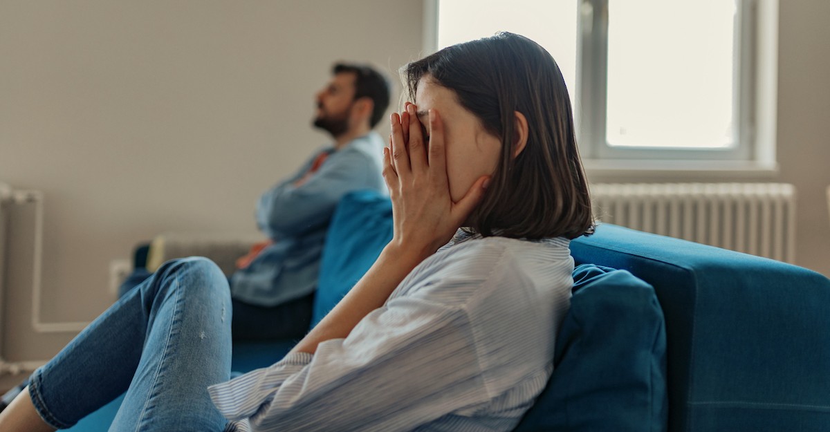 Couple on couch family conflict discussion arguing; the pitfalls of pride.