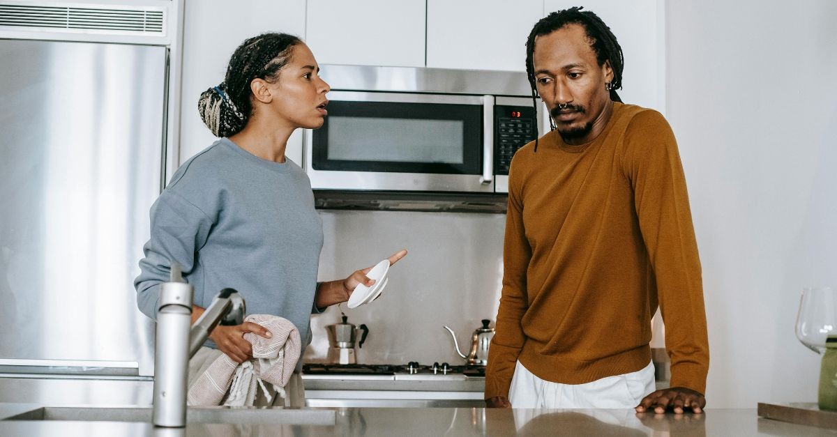 Angry couple arguing in the kitchen.