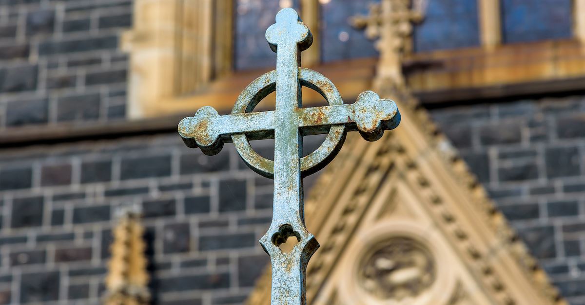 iron cross in front of old church, the anglican church